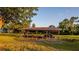 Exterior shot of an open wooden barn structure in a grassy field on a sunny day at 4561 Henry J Ave, St Cloud, FL 34772