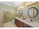 Well-lit bathroom with double vanities, decorative mirrors, and a tiled walk-in shower at 4561 Henry J Ave, St Cloud, FL 34772