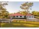 Charming home featuring a red roof, a large front yard, and a white fence at 4561 Henry J Ave, St Cloud, FL 34772