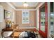 Welcoming foyer features a red front door, hardwood floors, and a decorative rug at 4561 Henry J Ave, St Cloud, FL 34772