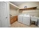 Well-equipped laundry room with washer, dryer, utility sink, and ample storage at 4561 Henry J Ave, St Cloud, FL 34772