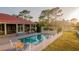 Picturesque backyard featuring a sparkling pool, well-manicured lawn, and classic white picket fence at 4561 Henry J Ave, St Cloud, FL 34772