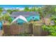 Fenced backyard with a canvas covered patio, shed, and exterior of the house at 4765 Lake Shore Dr, St Cloud, FL 34772