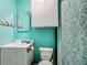 Charming bathroom with a white vanity, toilet, and a patterned shower curtain at 4765 Lake Shore Dr, St Cloud, FL 34772