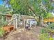 Backyard chicken coop offers fresh eggs in a serene, shaded environment at 4765 Lake Shore Dr, St Cloud, FL 34772