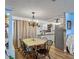 Traditional dining room featuring a chandelier, wood floors, and access to kitchen at 4765 Lake Shore Dr, St Cloud, FL 34772