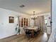 Dining room with traditional decor, chandelier, and views to a kitchen at 4765 Lake Shore Dr, St Cloud, FL 34772