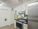 Well-equipped kitchen with white cabinets, black countertops, and modern stainless steel range at 4765 Lake Shore Dr, St Cloud, FL 34772