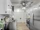 Functional kitchen with white cabinets, stainless steel appliances, and tile backsplash at 4765 Lake Shore Dr, St Cloud, FL 34772