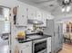 Cozy kitchen with stainless steel appliances, white cabinets, and black countertops at 4765 Lake Shore Dr, St Cloud, FL 34772