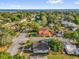 Aerial view of a neighborhood with mature trees and a glimpse of the lake in the distance at 503 New York Ave, St Cloud, FL 34769