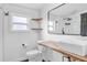 Modern bathroom featuring a wood vanity, black fixtures, and open shelving at 503 New York Ave, St Cloud, FL 34769