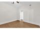 This bedroom features wood floors, a ceiling fan, and a white door at 503 New York Ave, St Cloud, FL 34769