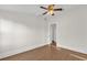 This bedroom features wood floors, white walls and trim, and a ceiling fan at 503 New York Ave, St Cloud, FL 34769
