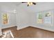 Well-lit bedroom featuring wood-look floors and multiple windows, creating a bright space at 503 New York Ave, St Cloud, FL 34769
