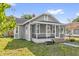 Side view showcasing the house's architecture and well-maintained lawn, blending comfort with outdoor appeal at 503 New York Ave, St Cloud, FL 34769