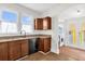 The kitchen has an attached laundry room, wooden cabinets and granite countertops at 503 New York Ave, St Cloud, FL 34769