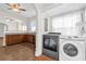 Convenient laundry area featuring a washer and dryer, seamlessly connecting to the kitchen for added functionality at 503 New York Ave, St Cloud, FL 34769