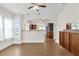 Open-concept living room featuring wood floors, bright windows, and seamless transition to the kitchen at 503 New York Ave, St Cloud, FL 34769