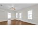 Living room with wood-look floors, bright windows, and white trim at 503 New York Ave, St Cloud, FL 34769
