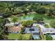 Aerial view of a home with a pool, solar panels, and proximity to a lush green lake at 5123 Lighthouse Rd, Orlando, FL 32808