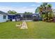 Inviting backyard featuring a pool, fire pit, and mature tropical landscaping at 5123 Lighthouse Rd, Orlando, FL 32808