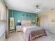 Bedroom with white tile flooring, decorative chandelier, and coordinated turquoise accent wall at 5123 Lighthouse Rd, Orlando, FL 32808