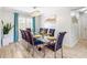 Elegant dining room with a glass-top table, seating for eight, and modern chandelier at 5123 Lighthouse Rd, Orlando, FL 32808
