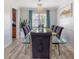 Elegant dining room with glass-top table, seating for eight, chandelier, and hardwood floors at 5123 Lighthouse Rd, Orlando, FL 32808