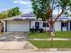 Charming home featuring solar panels, a well-maintained lawn, and a tidy front garden at 5123 Lighthouse Rd, Orlando, FL 32808