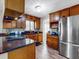 Kitchen featuring wood cabinets, stainless steel appliances, granite counters, and hardwood floors at 5123 Lighthouse Rd, Orlando, FL 32808