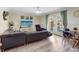 Inviting living room features an expansive sectional sofa and doors leading to the outdoor space at 5123 Lighthouse Rd, Orlando, FL 32808