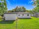 Back exterior view of the home featuring a well-kept lawn at 514 S Cottage Hill Rd, Orlando, FL 32805