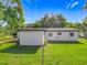 Back exterior view of the home featuring a well-kept lawn at 514 S Cottage Hill Rd, Orlando, FL 32805