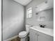 This bathroom is updated with gray tones, modern finishes and a new toilet and vanity at 514 S Cottage Hill Rd, Orlando, FL 32805