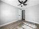 A quaint bedroom features wood floors, a fan and an adjoining room at 514 S Cottage Hill Rd, Orlando, FL 32805