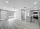 Bright, open-concept living area showcasing modern gray flooring and lots of natural light from large front window at 514 S Cottage Hill Rd, Orlando, FL 32805