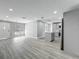 Bright, open-concept living area showcasing modern gray flooring and lots of natural light from large front window at 514 S Cottage Hill Rd, Orlando, FL 32805