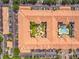 Bird's-eye view of a unique condo building that includes a courtyard, pool, terracotta roofs, and parking at 5550 E Michigan St # 2214, Orlando, FL 32822