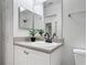 The bathroom has a neutral vanity with framed mirrors and black hardware fixtures at 5550 E Michigan St # 2214, Orlando, FL 32822