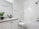 This bathroom features a shower and tub combination with a black faucet sink and white tile at 5550 E Michigan St # 2214, Orlando, FL 32822