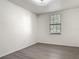 Bright bedroom with light colored hardwood floors and large window for natural light at 5550 E Michigan St # 2214, Orlando, FL 32822