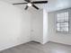 Sunlit bedroom with window and ceiling fan creating a serene and inviting atmosphere at 5550 E Michigan St # 2214, Orlando, FL 32822
