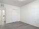 This bedroom features a neutral color palette, closet, and wood-look flooring at 5550 E Michigan St # 2214, Orlando, FL 32822