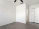 Minimalist bedroom features ceiling fan, light colored hardwood floors and natural light at 5550 E Michigan St # 2214, Orlando, FL 32822