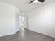 This bedroom features a neutral color palette, closet, and wood-look flooring at 5550 E Michigan St # 2214, Orlando, FL 32822