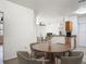 Cozy dining area with a round table and four chairs, adjacent to the living room at 5550 E Michigan St # 2214, Orlando, FL 32822