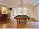 Game room with a beautiful pool table, pendant lighting, and a bar area perfect for entertaining at 5550 E Michigan St # 2214, Orlando, FL 32822