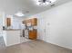 Clean kitchen features wood cabinets, white appliances, and breakfast bar at 5550 E Michigan St # 2214, Orlando, FL 32822