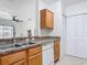 Features a double sink, dishwasher, and wooden cabinets, creating a functional kitchen area at 5550 E Michigan St # 2214, Orlando, FL 32822